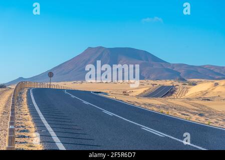Road passing through Corralejo sand dunes at Fuerteventura, Canary islands, Spain. Stock Photo