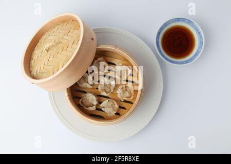 Shumai shaomai Chinese steamed meat dumpling on white background Stock Photo