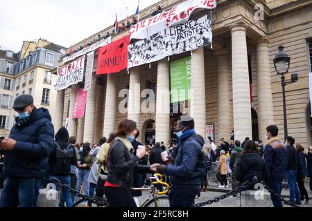 Paris, France. 27th Mar, 2021. Demonstrators gather as union members hang banners and flags from the balcony of the Odeon theatre in Paris, to demand the reopening of cultural establishments in France. French protesters had occupied three of the country's four national theatres on Wednesday to demand an end to the closure of cultural venues imposed due to the pandemic as frustration grows with the months-long halt to performances. (Photo by Lionel Urman/Sipa USA) Credit: Sipa USA/Alamy Live News Stock Photo