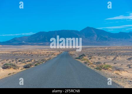 Road passing through Jandia peninsula at Fuerteventura, Canary islands, Spain. Stock Photo