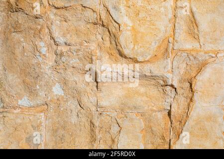 golden yellow stone wall, background texture Stock Photo