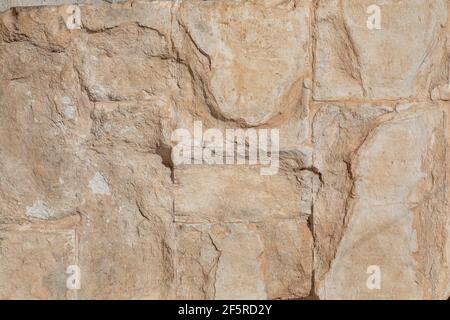 golden yellow stone wall, background texture Stock Photo