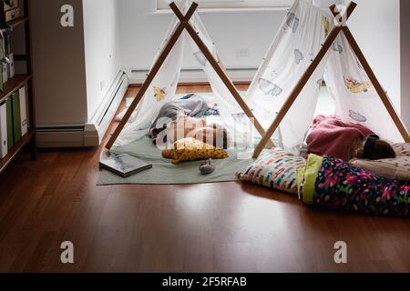 Two sleeping kids inside in tents Stock Photo