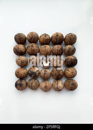 Flat lay whole and cracked walnuts on a white background Stock Photo