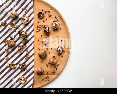 Cracked walnuts on a wooden board and white copy space background. Stock Photo