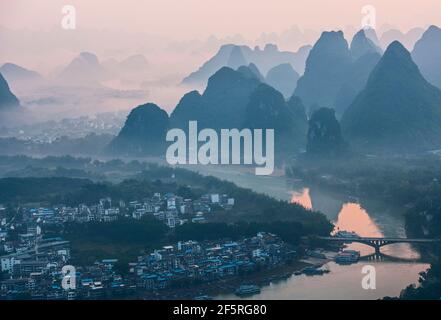 mist around limestone peaks in Yangshuo in Guangxi province / China Stock Photo