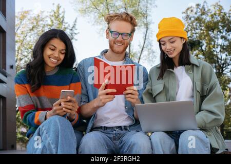 Group of happy multiracial students studying together, learning language, preparing for exam, education concept Stock Photo