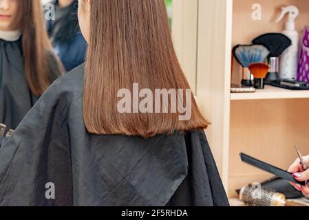 Happy Girl Getting her Hair Cut. A series of photos of a girl getting her hair  cut. haircut, girl Stock Photo - Alamy