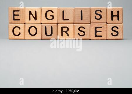 Language Courses English online learn icon cube. Wooden block toy cubes concept learning English Courses training. Speak English Courses icon words Stock Photo