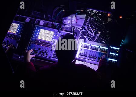 Berlin, Germany. 27th Mar, 2021. A person operates a mixing console at a test concert entitled 'Operation Heartbeat' in the 'Säälchen' on the Holzmarkt. All event participants took a Corona quick test in advance. The project aims to test the logistical feasibility of events in conjunction with Sars-CoV-2 antigen testing in order to develop feasible scenarios for the reopening of the culture. Credit: Christoph Soeder/dpa/Alamy Live News Stock Photo