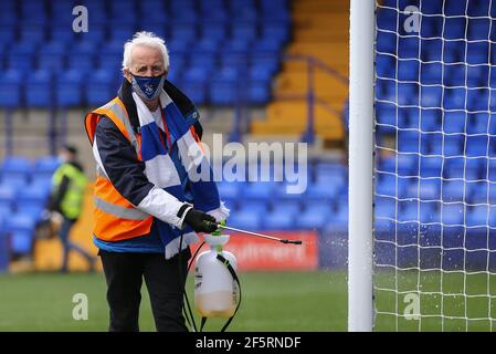 Birkenhead, UK. 27th Mar, 2021. A Tranmere Rovers steward disinfects the goal posts. EFL Skybet Football league two match, Tranmere Rovers v Mansfield Town at Prenton Park, Birkenhead, Wirral on Saturday 27th March 2021. this image may only be used for Editorial purposes. Editorial use only, license required for commercial use. No use in betting, games or a single club/league/player publications.pic by Chris Stading/Andrew Orchard sports photography/Alamy Live News Credit: Andrew Orchard sports photography/Alamy Live News Stock Photo