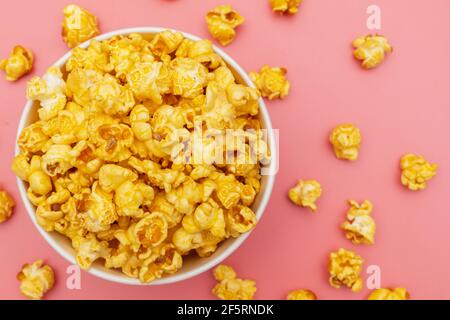 Caramel of pop icons in multicolored cups on pink background Stock Photo