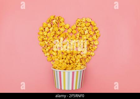 Caramel of pop icons in multicolored cups on pink background Stock Photo