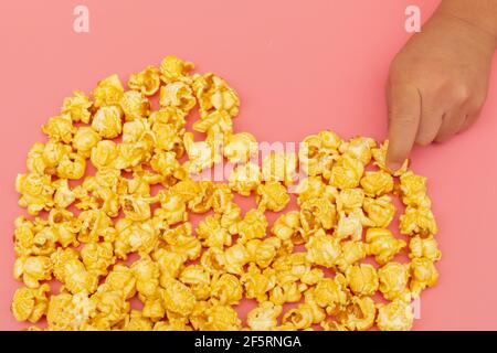 Caramel of pop icons in multicolored cups on pink background Stock Photo