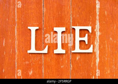 Alphabet letter in word lie on old red color wood plate background Stock Photo