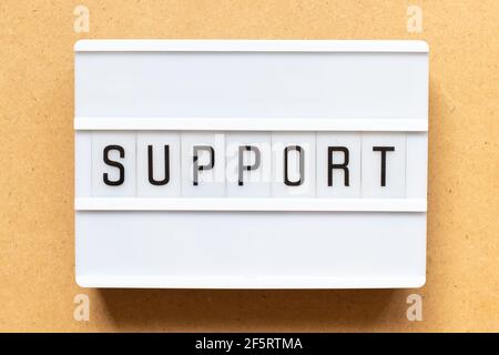 Lightbox with word support on wood background Stock Photo