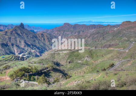 Pico de Teide viewed behind mountainous landscape of Gran Canaria, Canary Islands, Spain. Stock Photo