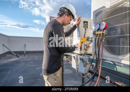 Professional HVAC technician taking amperage on a mini-split ductless ...