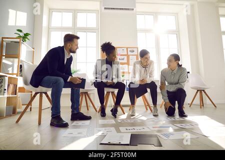 Team of young business professionals developing new strategies in an office meeting Stock Photo