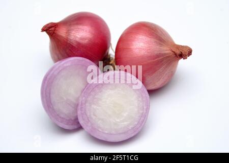 Three cloves of red onion on white background Stock Photo