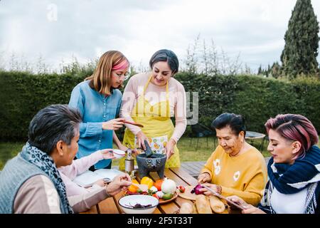latin mother and daughter cooking together mexican food at home in Mexico city Stock Photo