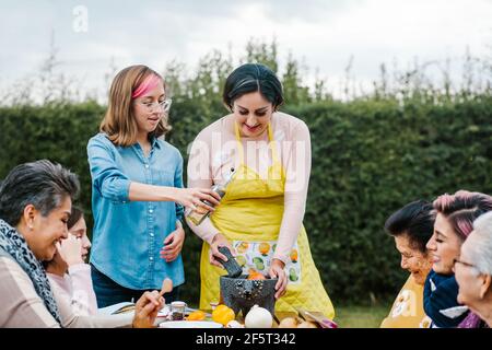 latin mother and daughter cooking together mexican food at home in Mexico city Stock Photo