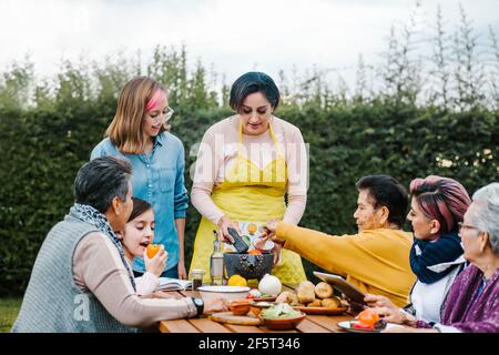 latin mother and daughter cooking together mexican food at home in Mexico city Stock Photo