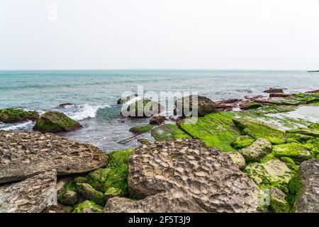 Rocky sea beach with boulders Stock Photo