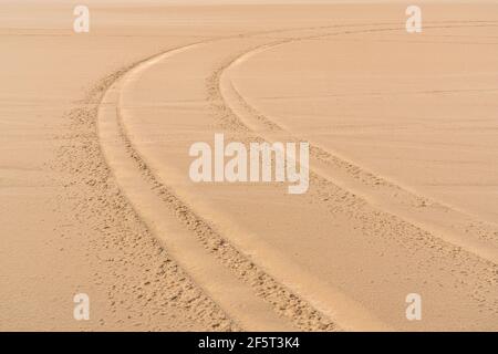 Car tread marks in the sand Stock Photo