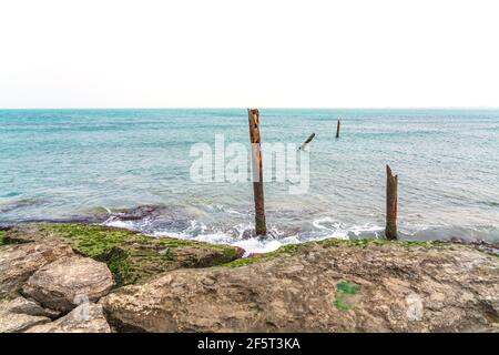 Remains of an old pier on shore Stock Photo