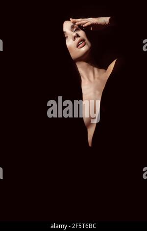 Closeup portrait of brunette woman hiding in shade Stock Photo