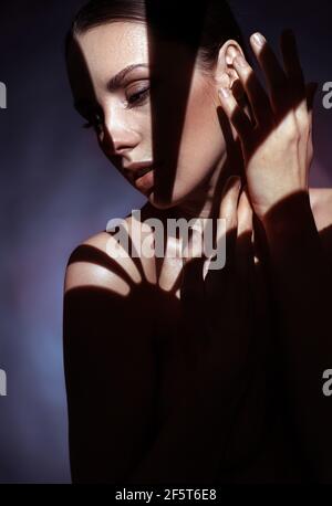 Closeup portrait of brunette woman hiding in shade Stock Photo