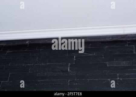 Wall with black bricks or straps tiles. Stock Photo