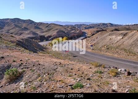 Steppe landscape with a section of asphalt winding road in Central Asia; bridge over the Charyn river in the canyon of the same name in Kazakhstan Stock Photo