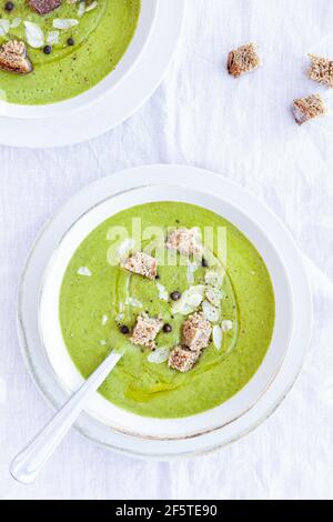 From above of yummy zucchini cream soup with croutons in bowl served on table at home Stock Photo