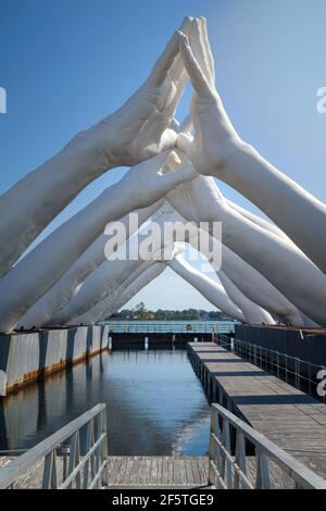 Huge white hands of Building Bridges sculpture by Lorenzo Quinn in the Biennale Art Exhibition Arsenale in Venice Stock Photo