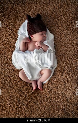 Serenity very little baby sleeping, newborn boy with funny woolen hat Stock Photo