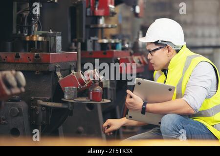 engineer man, or technicians wearing surgical mask and using computer notebook for Checking Stock Photo