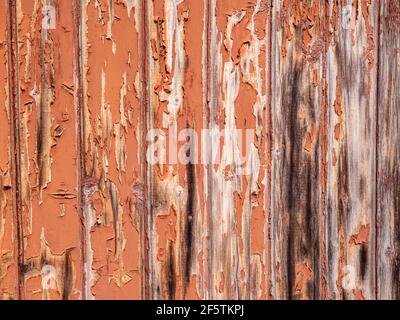 Brown wooden wall where the paint is peeling Stock Photo