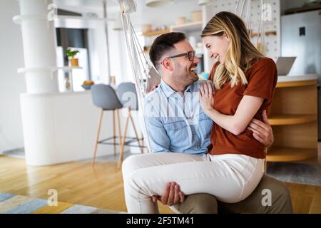 Cute couple in love hugging and having great time together at home Stock Photo