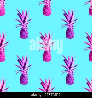 Seamless pattern of pink pineapples isolated on blue background Stock Photo