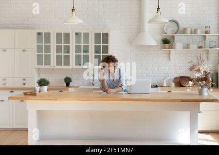 Young Caucasian woman study online on laptop from home Stock Photo