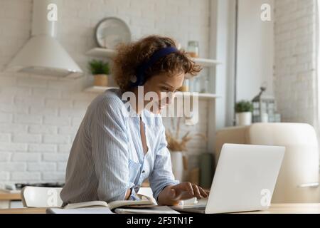 Smiling young woman study online on computer Stock Photo