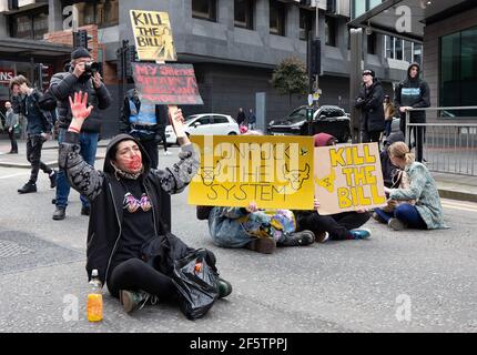 Manchester, UK. 27th March 2021. Protesters stage a sit-in protest at Portland street Manchester during a 'Kill The Bill' demonstration. The government's new legislation will give the police more powers to control protests. Picture: Gary Roberts