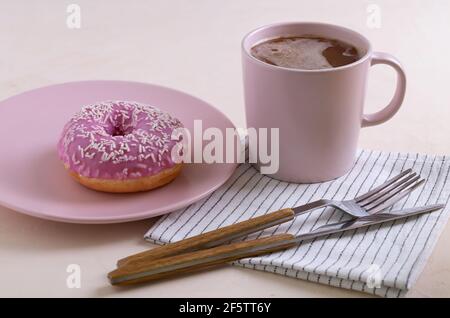 Two sugar-coated donuts lie on a pink ceramic plates. Stock Photo