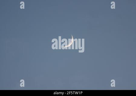 Waxing crescent moon in the evening sky Stock Photo