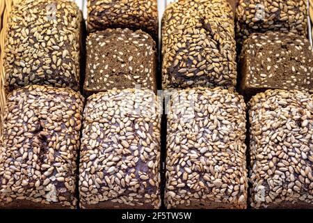 Rye bread with sunflower seeds on shelf in market. Stock Photo