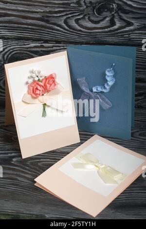 Handmade greeting cards. Various colors and decorative elements. They lie on pine boards. Stock Photo