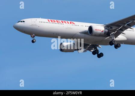 Iberia airline Airbus A330 jet airliner plane EC-LZJ on finals to land at London Heathrow Airport, UK, in blue sky. Spanish flag carrier. Part of IAG Stock Photo