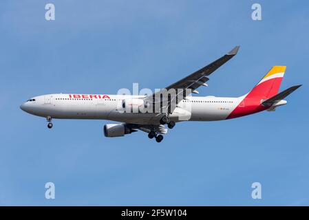 Iberia airline Airbus A330 jet airliner plane EC-LZJ on finals to land at London Heathrow Airport, UK, in blue sky. Spanish flag carrier. Part of IAG Stock Photo